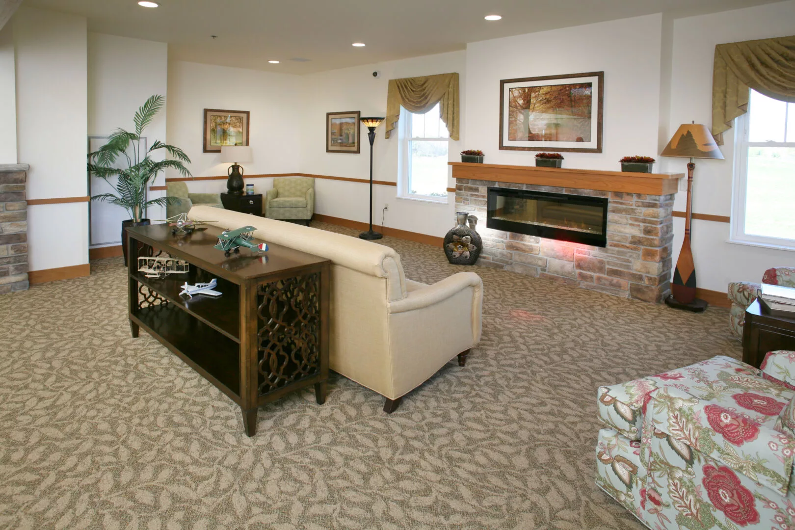 A cozy living room featuring a comfortable sofa, modern decor, and a fireplace.