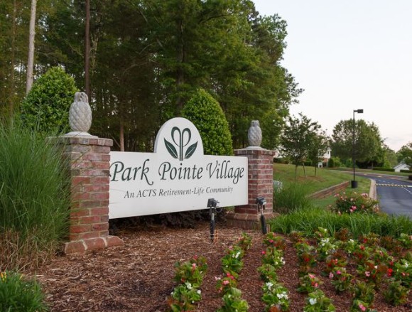 Entrance sign to Park Pointe Village surrounded by landscaped gardens.