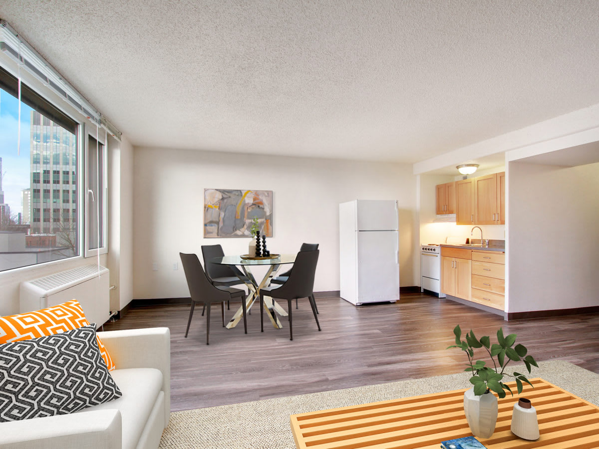A modern apartment interior featuring an open-plan living room, dining area, and kitchen.
