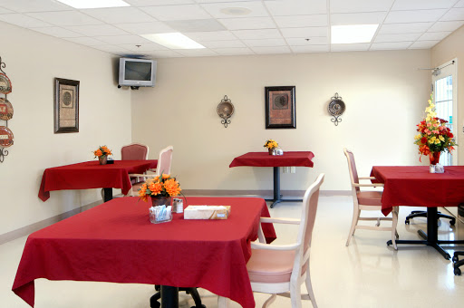 A cozy dining area featuring tables with red tablecloths and decorative elements.