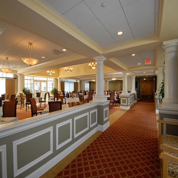 Elegant dining area with tables, chairs, and chandeliers.