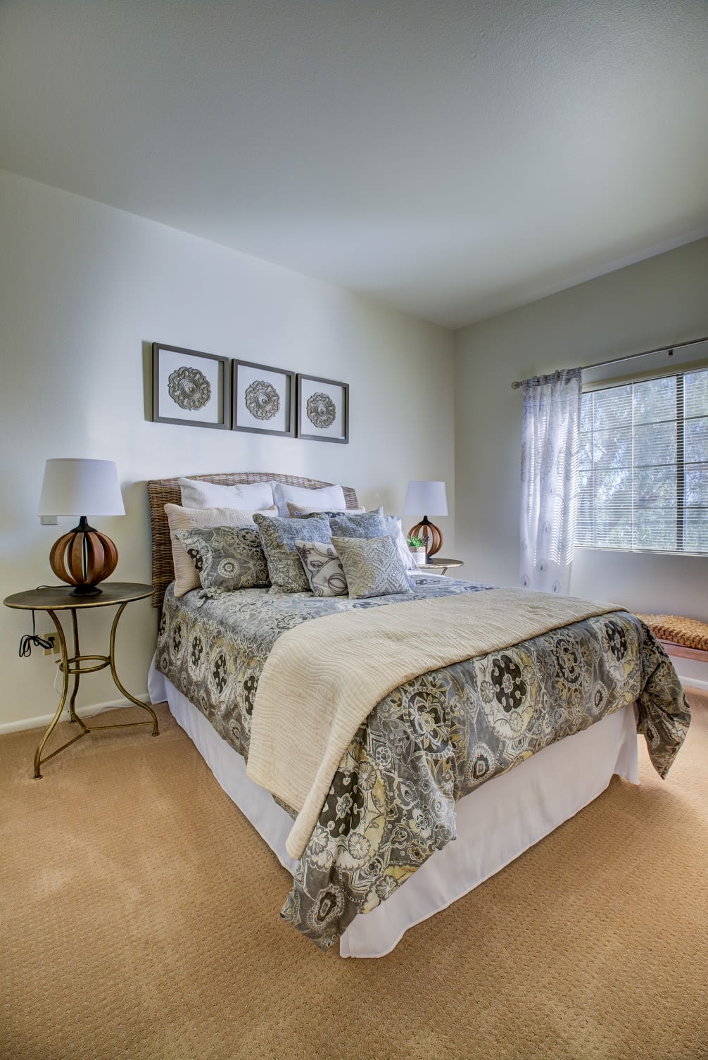 A cozy and elegantly decorated bedroom with a neatly made bed and stylish furnishings.