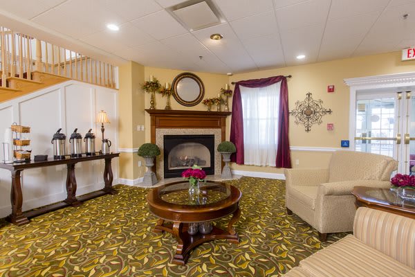 A cozy living room featuring a fireplace, elegant furniture, and tasteful decor.