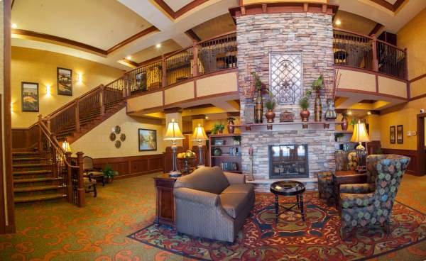 A cozy hotel lobby featuring a stone fireplace and comfortable seating.
