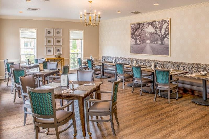 A beautifully arranged dining area in a restaurant featuring elegant decor and wooden flooring.