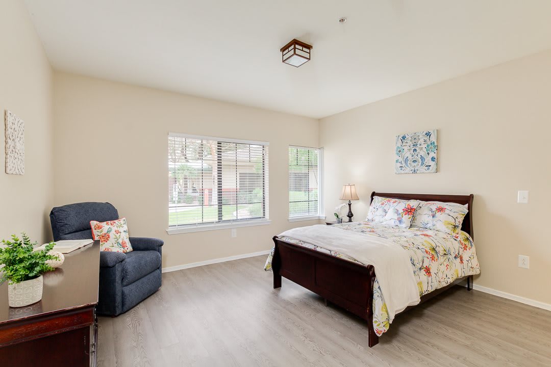 A cozy bedroom with a large window and stylish decor.