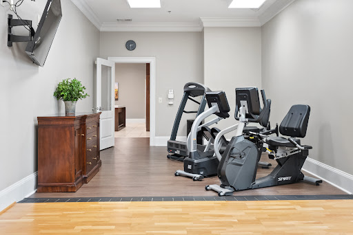 A well-equipped home gym featuring modern exercise machines and a stylish interior.