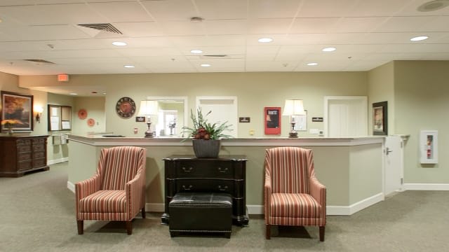 A well-arranged reception area with comfortable seating and decor.