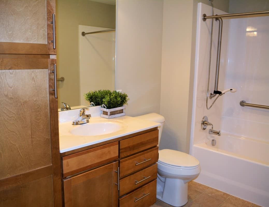 A cozy bathroom with a sink, toilet, and bathtub.