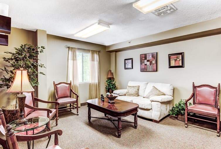 A cozy living room with a sofa, chairs, and a coffee table.