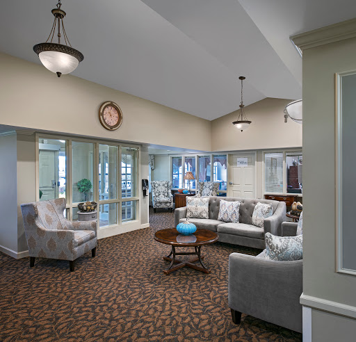 A cozy and inviting lobby area featuring comfortable seating, elegant lighting, and a warm atmosphere.