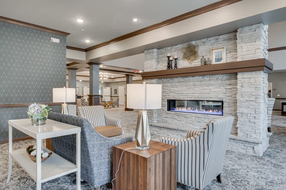 A modern living room with comfortable seating and a sleek fireplace.