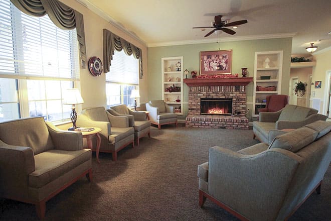 A cozy living room with comfortable seating and a warm fireplace.
