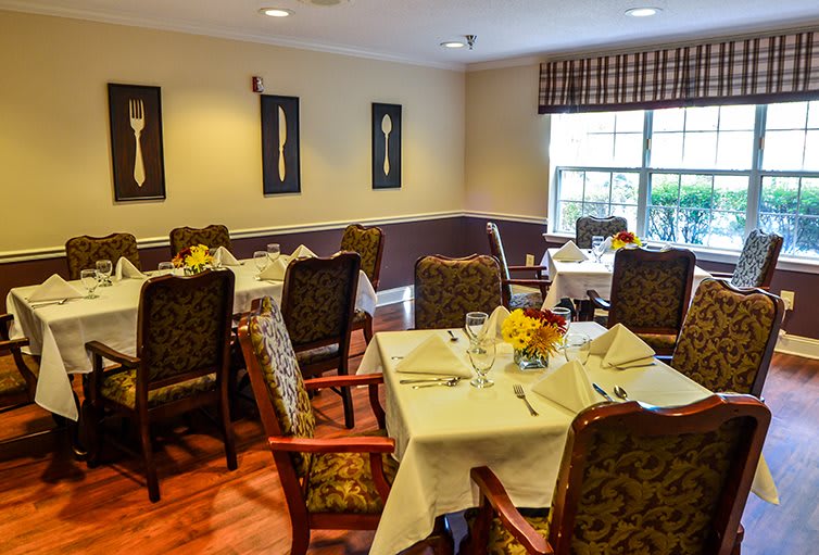 A cozy dining room with elegantly set tables and classic decor.