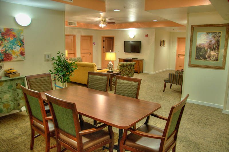 A warm and inviting living room with comfortable seating, a large table, and a television for entertainment.