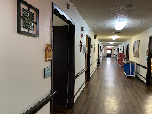 A well-lit corridor featuring various doors and wall decorations.