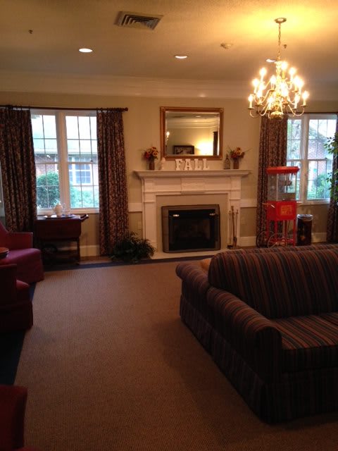 Cozy living room with a fireplace and elegant chandelier.