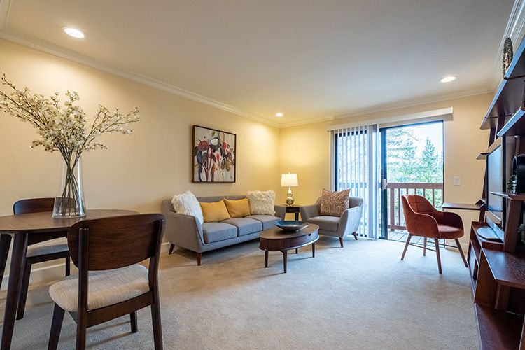 A cozy and inviting living room with comfortable seating and ample lighting.