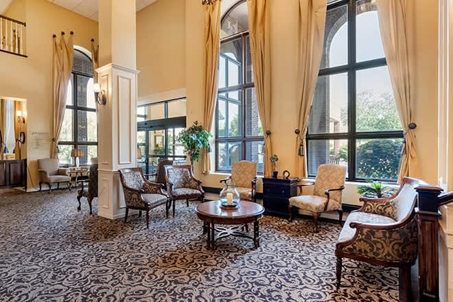 Elegant hotel lobby with classic furniture and large windows.