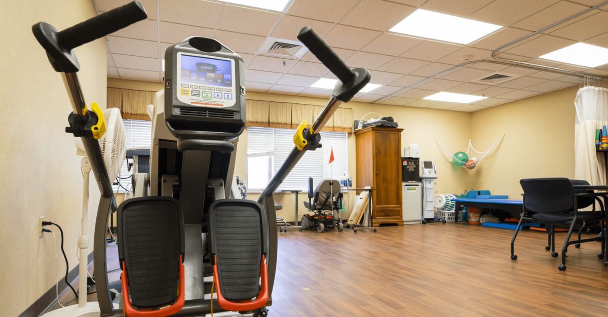 An exercise machine in a spacious rehabilitation center.