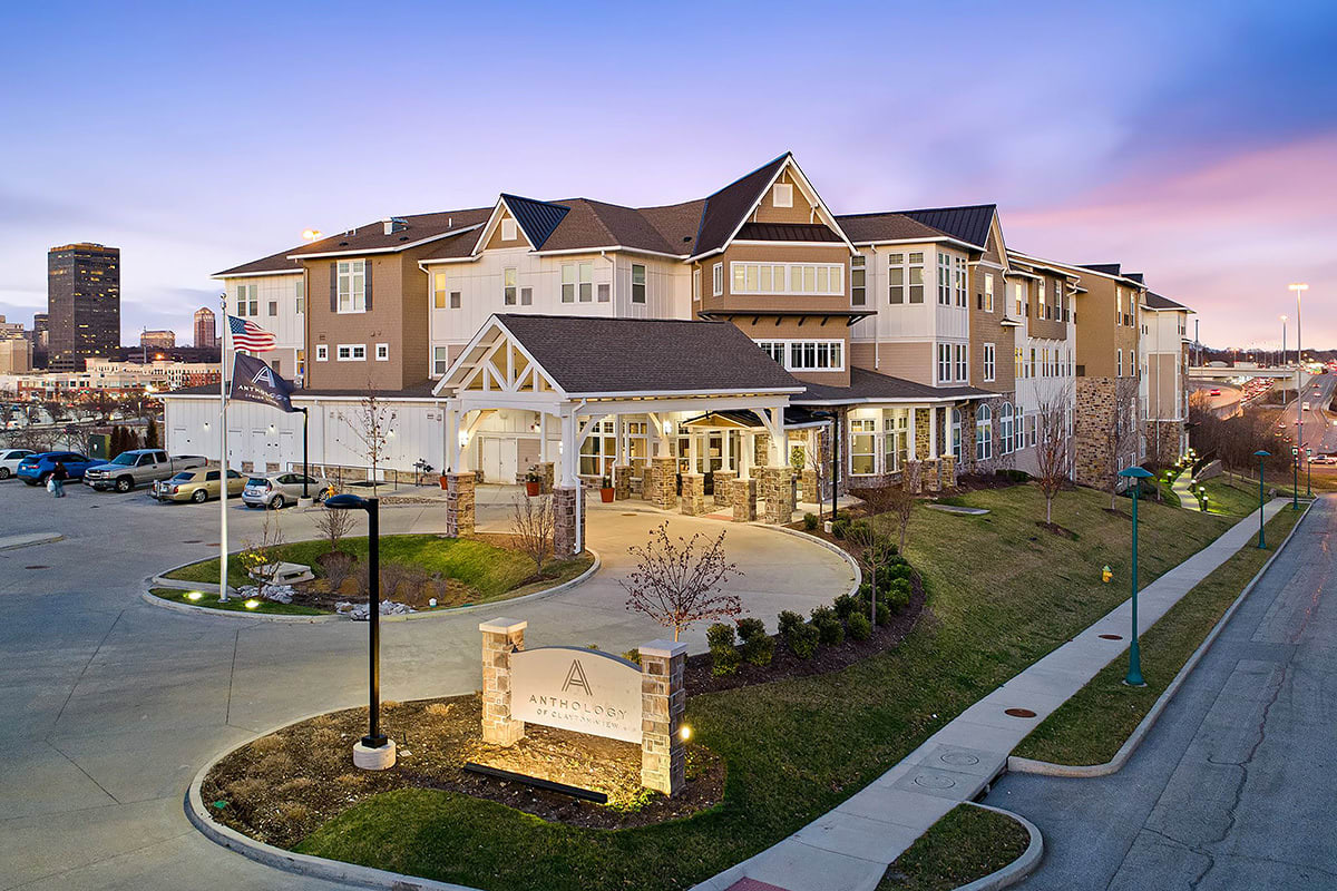A picturesque residential building with well-manicured landscaping during the evening.