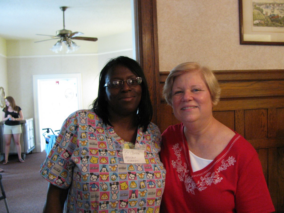 Two women posing together indoors.