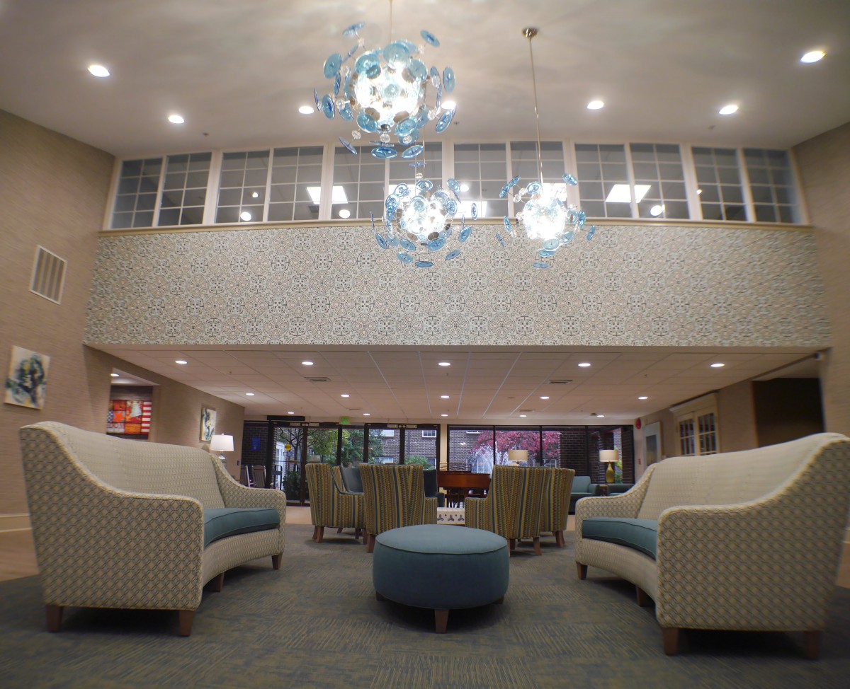 A modern lobby with elegant chandeliers and comfortable seating arrangements.