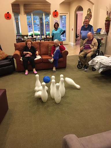 Residents enjoying a fun bowling activity at the community center.
