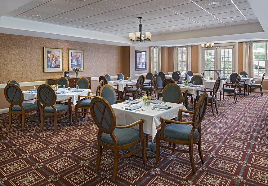 A well-appointed dining room with elegantly set tables and classic decor.
