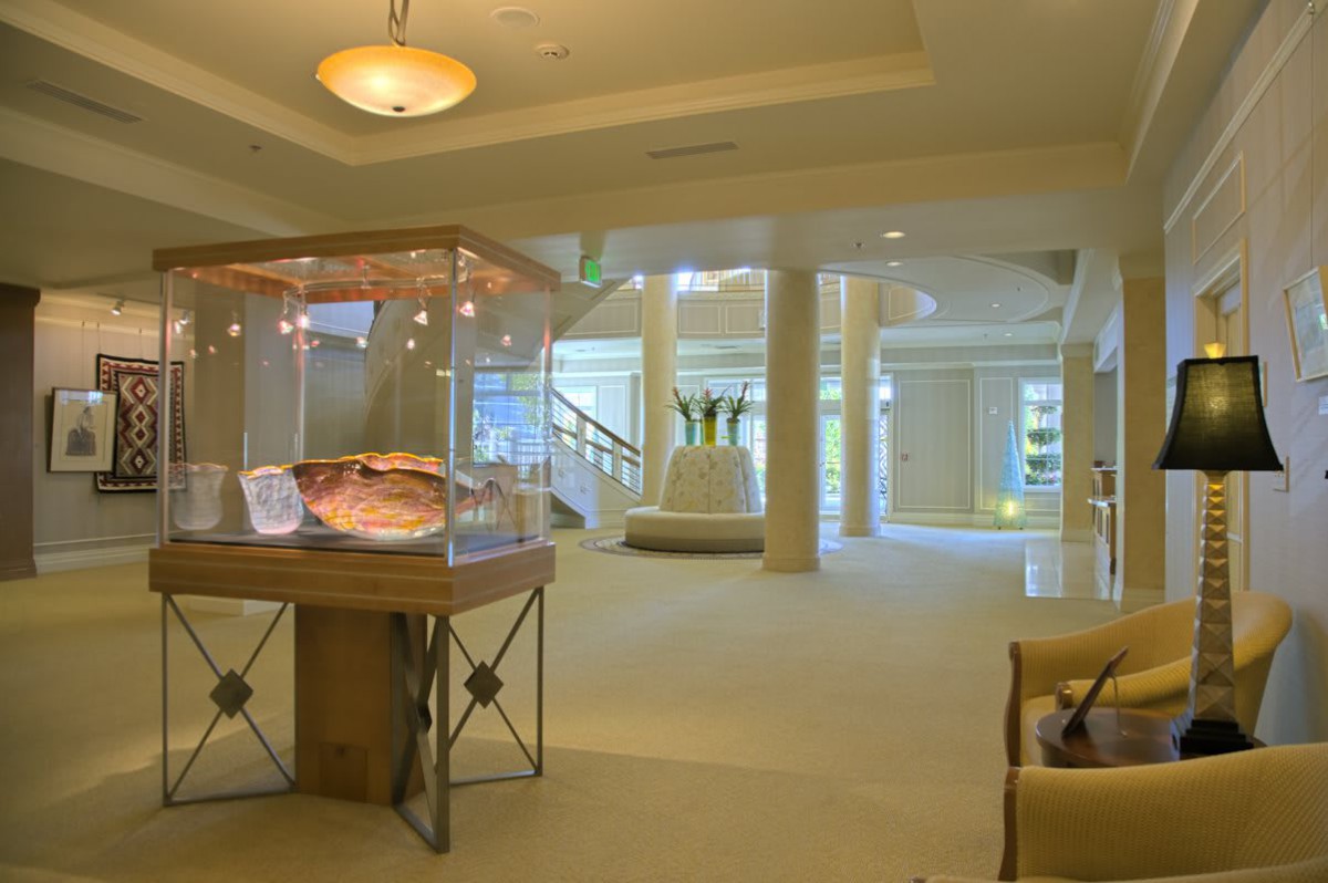 A modern museum interior featuring a display case with artifacts.