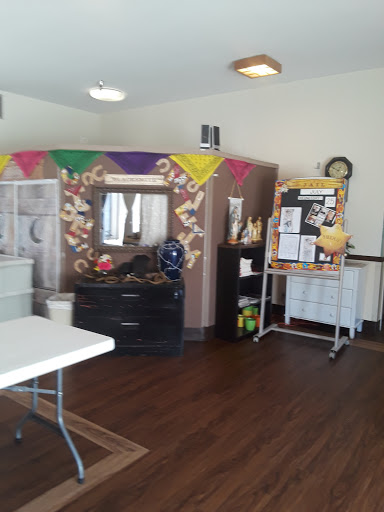 A decorated community space with tables and festive colors, ready for an event.