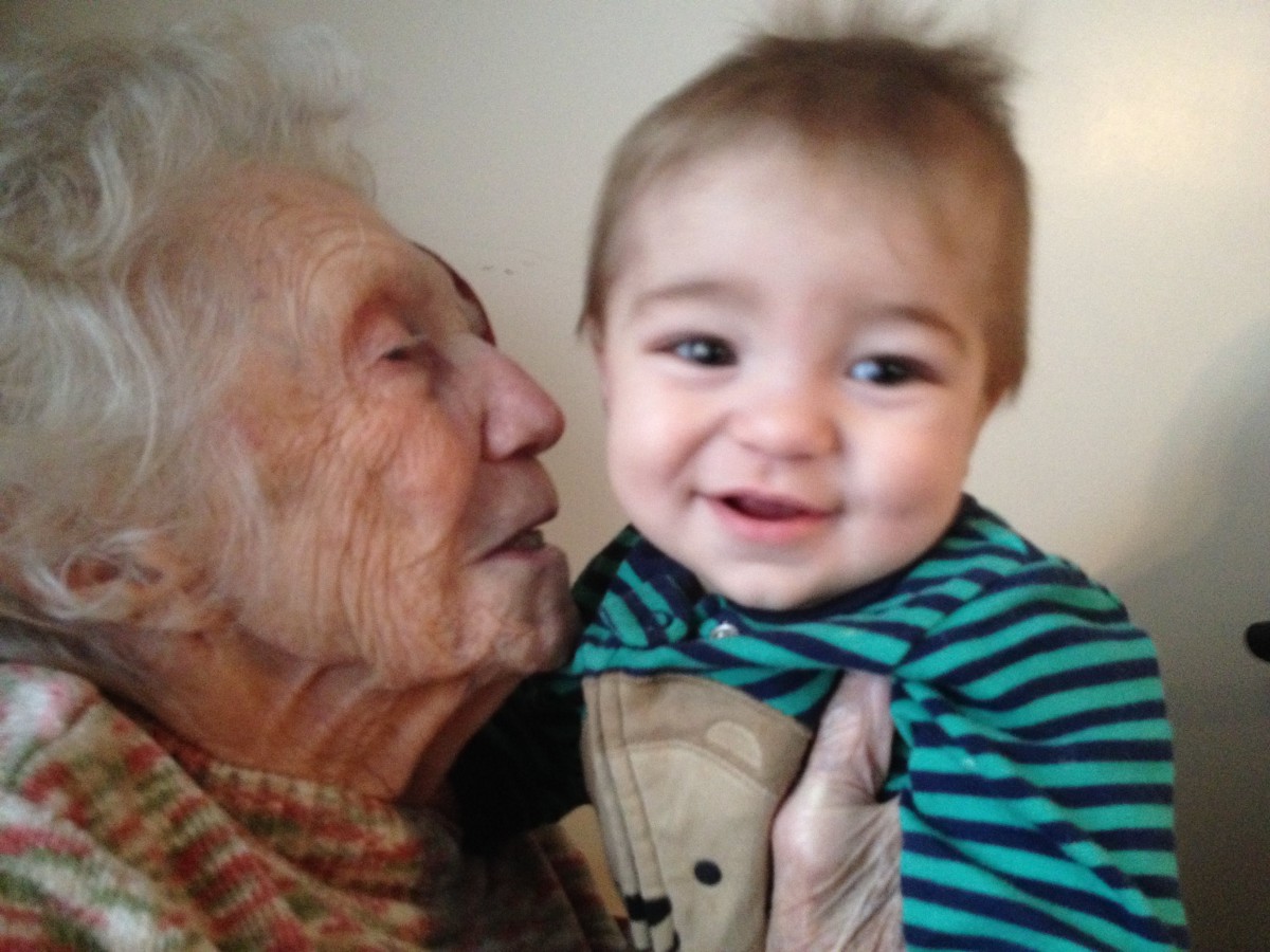 An elderly woman cherishing a moment with a smiling baby.