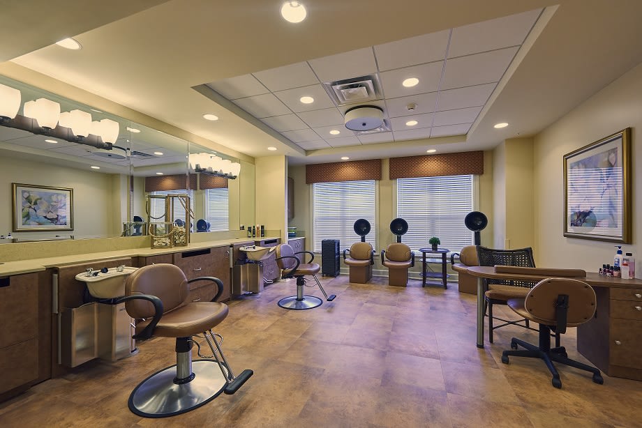 A modern hair salon interior with styling chairs and mirrors.