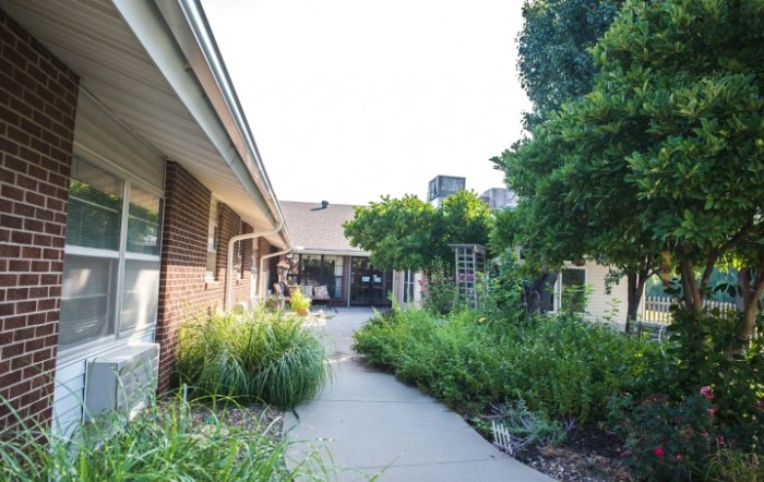 A beautifully landscaped garden pathway lined with lush greenery.