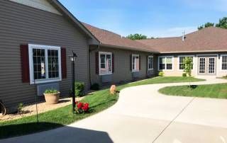 A residential house with a curved driveway and well-maintained garden.