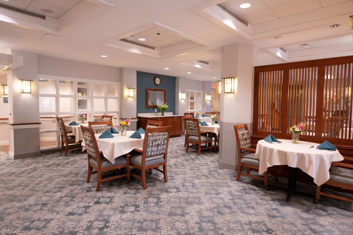 An elegant dining room with neatly arranged tables and chairs.