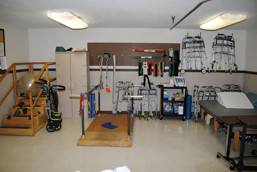 A well-equipped physical therapy room featuring various rehabilitation tools and equipment.