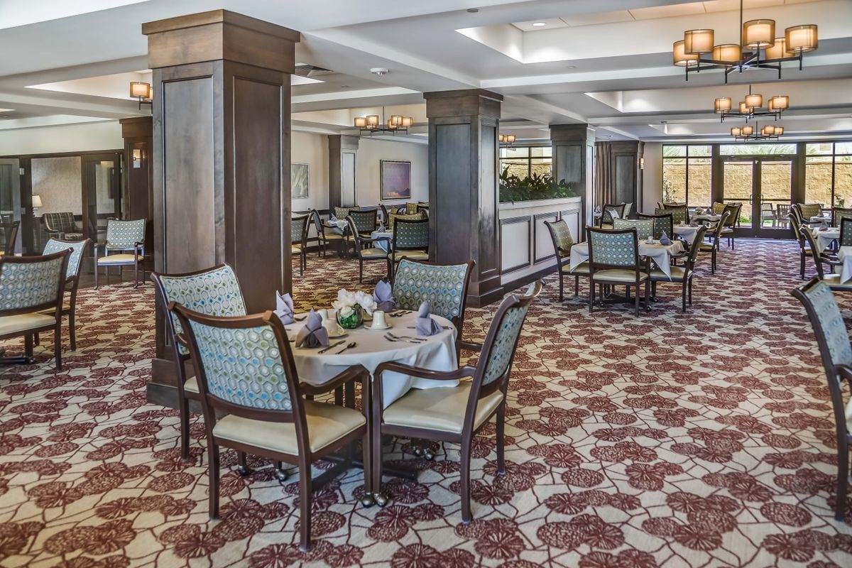 An elegant dining room with neatly arranged tables and chairs.