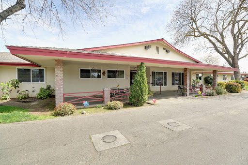 A charming single-story residential building with a welcoming exterior and well-maintained landscaping.