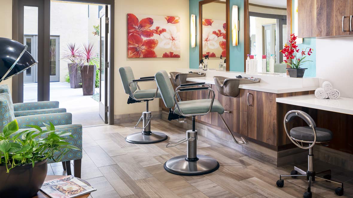 A stylish hair salon interior with chairs and mirrors.