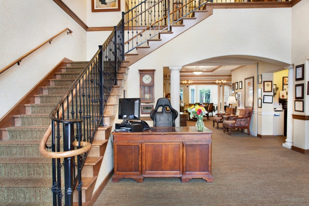 A welcoming reception area with a staircase and elegant interior design.