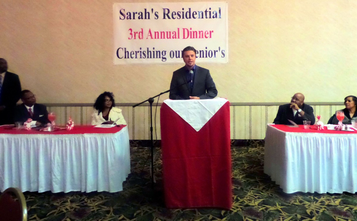 A speaker at the podium during Sarah's Residential 3rd Annual Dinner event.