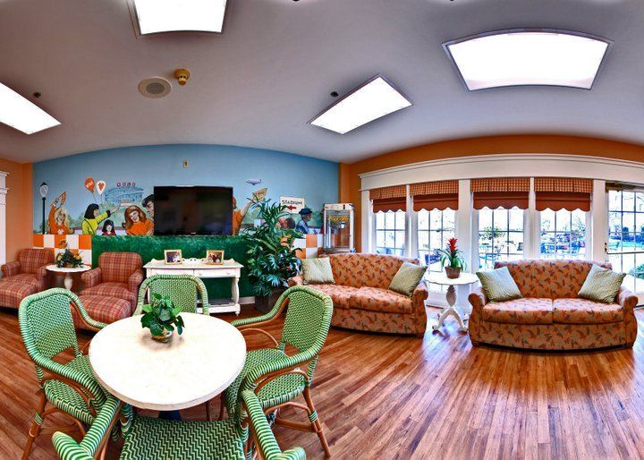 A bright and cozy living room with comfortable sofas, a small table, and plenty of natural light.
