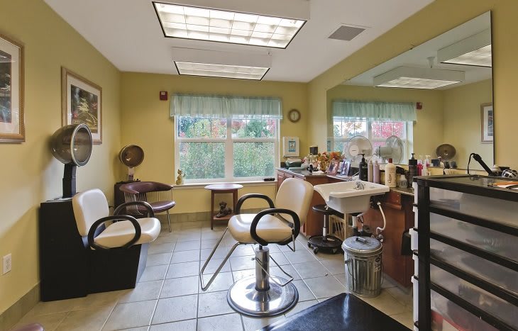 A cozy hair salon interior with styling chairs and mirrors.