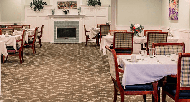 A cozy dining area with neatly arranged tables and chairs, complete with tablecloths and elegant decor.