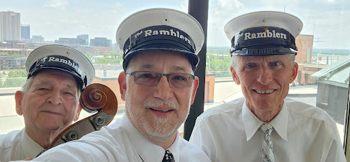 Two individuals taking a cheerful selfie, both wearing matching hats.