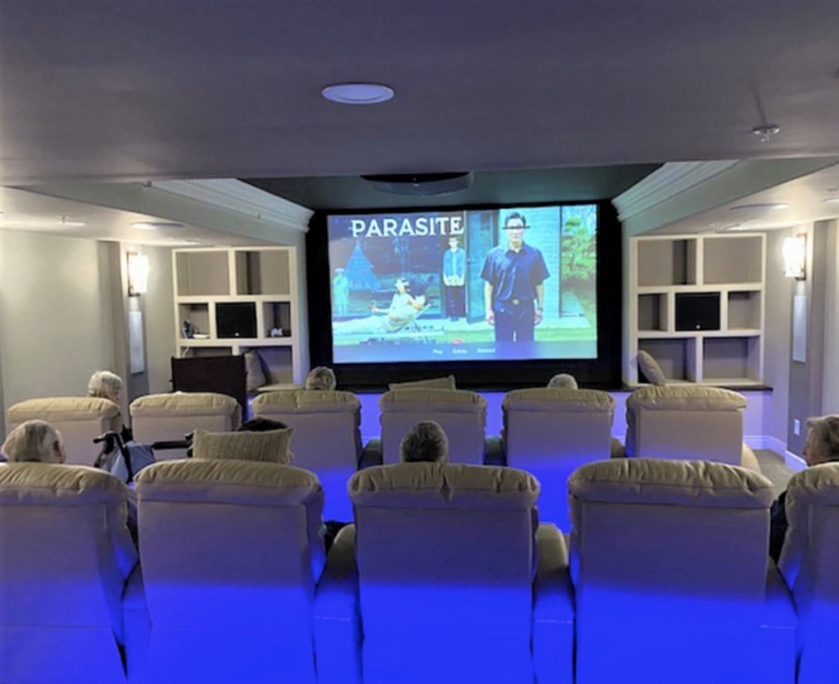 A cozy home theater setup showcasing a movie on the big screen.