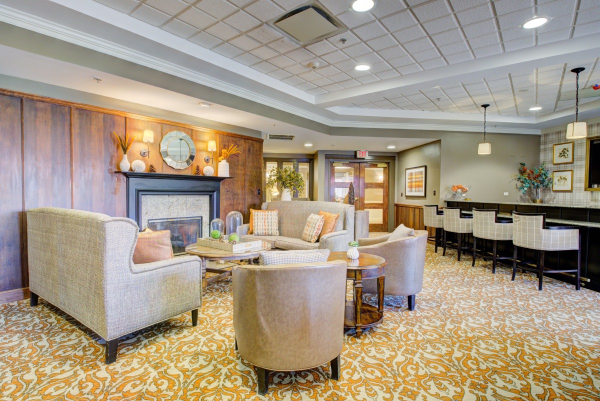 A modern and cozy living room with comfortable seating and a fireplace.