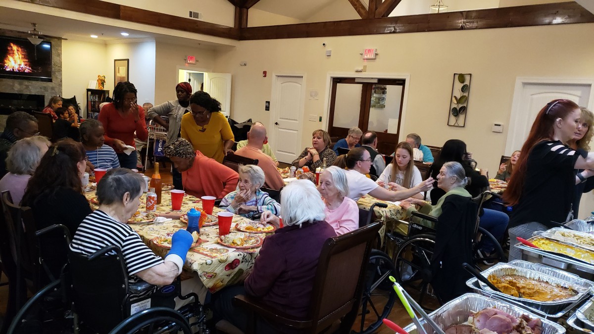 A group of elderly individuals gathered for a community event in a nursing home, enjoying social activities and companionship.