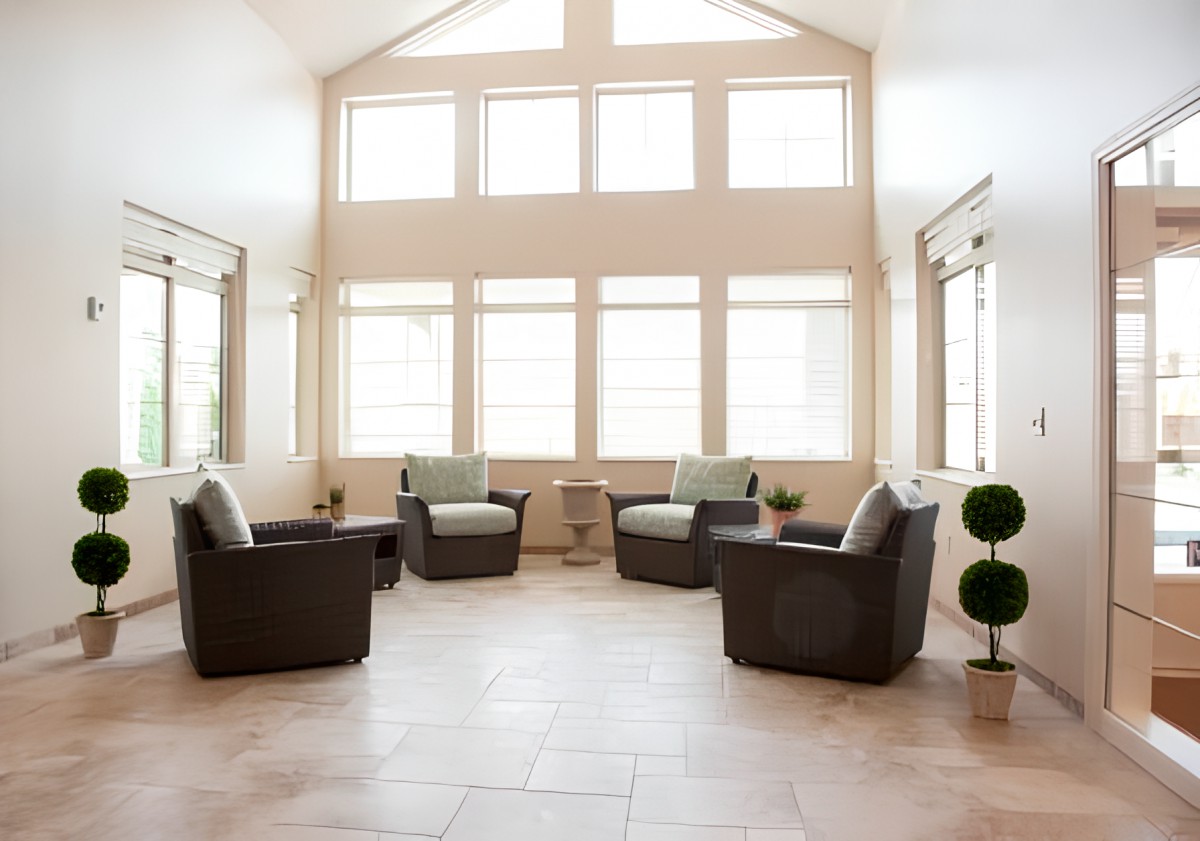 A modern living room with ample natural light and stylish furniture.